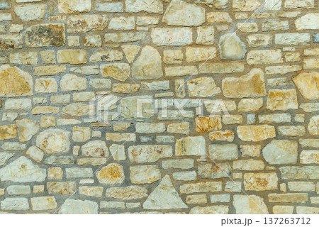 Wall made of stone bricks. 137263712