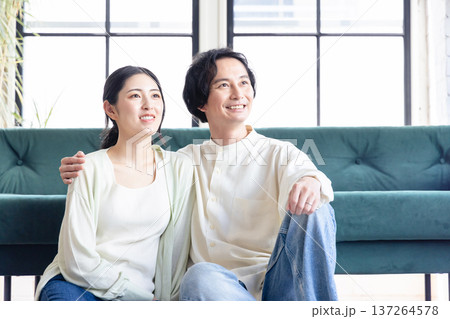 リビングでくつろぐ若い夫婦 リビングでくつろぐ若い夫婦 137264578