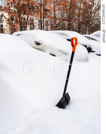 snow shovel andcars covered with deep snowdrif snow shovel andcars covered with deep snowdrif 137264659