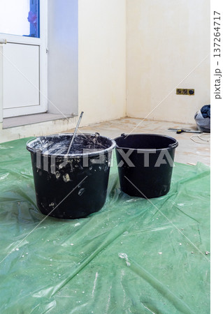 buckets on floor covered with protective film buckets on floor covered with protective film 137264717