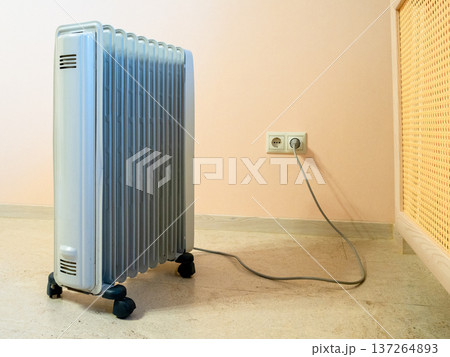 electric oil heater in residential apartment electric oil heater in residential apartment 137264893