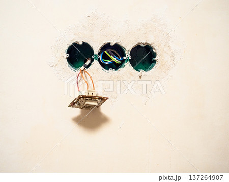 plastered wall with sockets for electrical outlets 137264907