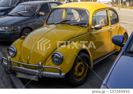 Yellow retro car parked in outdoor parking area, vintage transport concept. 137264950