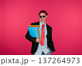 Stylish student holding colorful folders smiling on pink background 137264973