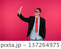 Stylish person taking selfie with smartphone on pink backdrop 137264975