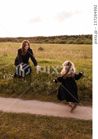 Child Playing Freely With Mother. Happy Childhood Moment Captured In Sunny Grassy Field Child Playing Freely With Mother. Happy Childhood Moment Captured In Sunny Grassy Field 137264992