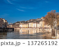 Lyon, france. December 27, 2023. Lyon cityscape along the saone with historic riverside buildings, bridge and bare winter trees reflected under a clear blue sky 137265192