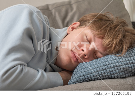 Young man sleeping on sofa. Leisure Activities At Home 137265193