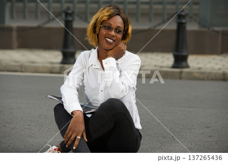 smiling girl outdoors at university. 137265436