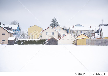 Residential houses in the village of Emmering covered in fresh snow with an open field in the foreground, Bavaria, Germany Residential houses in the village of Emmering covered in fresh snow with an open field in the foreground, Bavaria, Germany 137266381