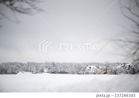 Residential houses in the village of Emmering covered in fresh snow with an open field in the foreground, Bavaria, Germany Residential houses in the village of Emmering covered in fresh snow with an open field in the foreground, Bavaria, Germany 137266385