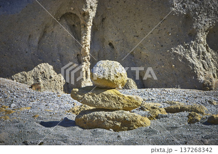 Rock Cairn Stone Stack in Sunlit Arid Landscape with Eroded Natural Backdrop Rock Cairn Stone Stack in Sunlit Arid Landscape with Eroded Natural Backdrop 137268342