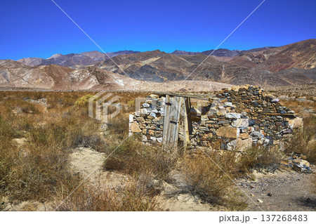 Abandoned Stone Structure Desert Brush and Rugged Mountains in Bright Death Valley 137268483