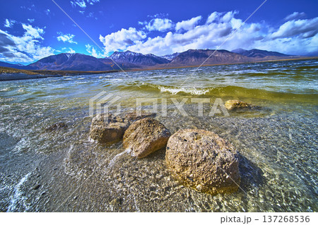 Crowley Lake Shoreline Stone Columns and Snowy Sierra Mountains Under Blue Sky 137268536
