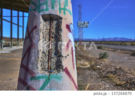 Abandoned Graffiti Covered Concrete Pillar and Faded Bar Sign in Desert California Abandoned Graffiti Covered Concrete Pillar and Faded Bar Sign in Desert California 137268870
