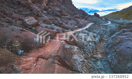 Aerial Rugged Desert Trail and Rocky Lava Butte Landscape in Nevada 137268952