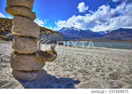 Rock Stack on Sandy Shore with Crowley Lake Stone Columns and Snowy Sierra Mountains Rock Stack on Sandy Shore with Crowley Lake Stone Columns and Snowy Sierra Mountains 137269071