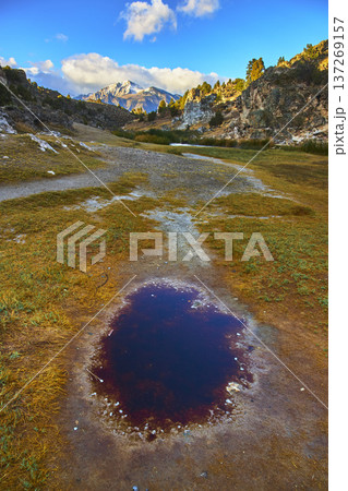 Mountain Landscape with Hot Spring Pool and Rocky Terrain in Vibrant Light Mountain Landscape with Hot Spring Pool and Rocky Terrain in Vibrant Light 137269157