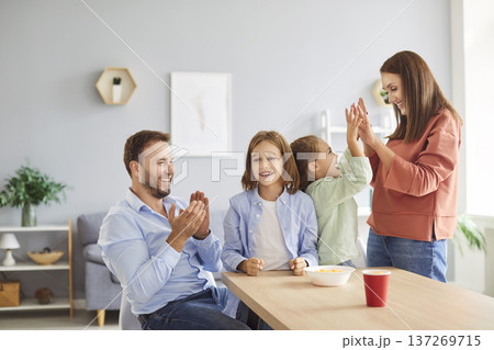Parents And Kids Celebrating Victory While Playing A Game Together At Home 137269715