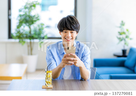 スマホを見る若い男性 137270081