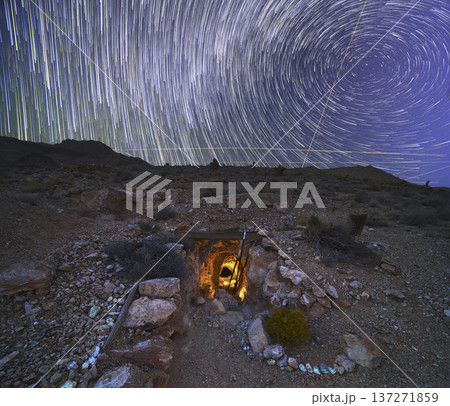 Abandoned Mine Entrance With Star Trails and Light Painting in Nevada Desert Night 137271859