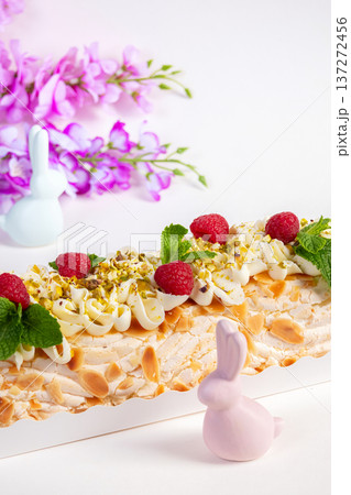 Easter meringue cream cheese roll with raspberries and nuts. Easter meringue cream cheese roll with raspberries and nuts. 137272456