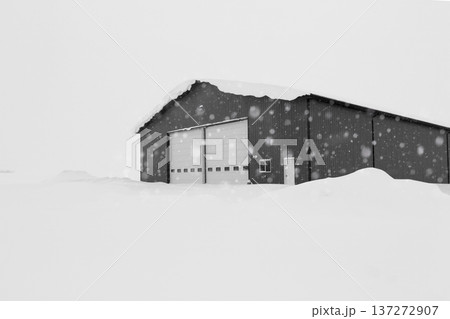 Industrial storage building covered with snow after snowfall. 137272907