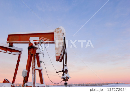 Snow Covered Oil Pumpjack at Winter Sunrise Snow Covered Oil Pumpjack at Winter Sunrise 137272924