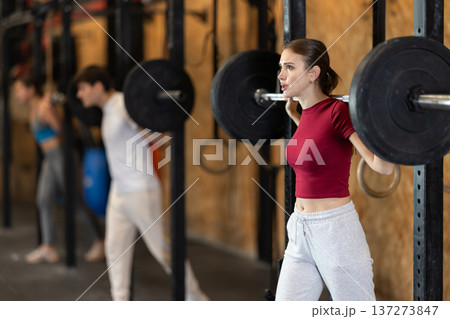 Woman with a barbell in the gym Woman with a barbell in the gym 137273847