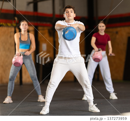 Man exercising with a kettlebell Man exercising with a kettlebell 137273959