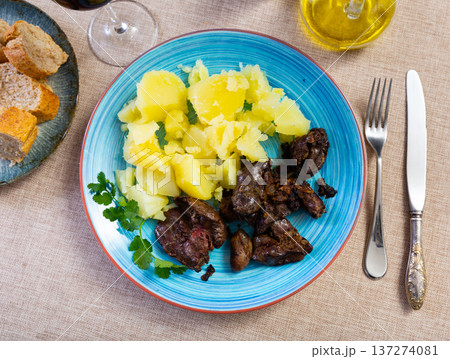 Dish made with chicken liver, heart, and potatoes 137274081