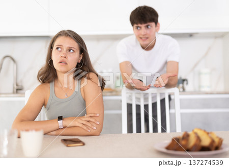 Young guy quarrels with young woman in kitchen 137274539