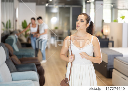 Adult woman looking around in furniture store Adult woman looking around in furniture store 137274640