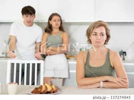 Adult children guy and girl are fighting with elderly woman mother. Adult children guy and girl are fighting with elderly woman mother. 137274945