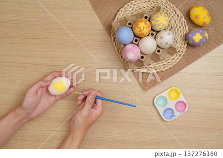 Easter Crafting. Painting colorful eggs for festive spring decor. Easter Crafting. Painting colorful eggs for festive spring decor. 137276180