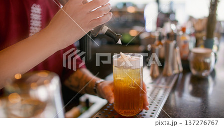 Cocktail bar. Cold cream drink. Bartender adding whipped milk top with siphon to cold ice syrup water. Preparing flavored beverage glass. Cocktail bar. Cold cream drink. Bartender adding whipped milk top with siphon to cold ice syrup water. Preparing flavored beverage glass. 137276767