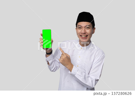 Individual in white shirt showcasing mockup smiling broadly Individual in white shirt showcasing mockup smiling broadly 137280626