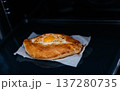Khachapuri on baking paper is baked in the oven. We cook khachapuri with our own hands at home. Delicious quick dishes Khachapuri.  137280735