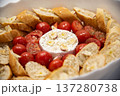 Camembert cheese baked with tomatoes and baguette, herbs and garlic. An excellent appetizer for wine. View from above.  137280738