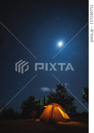 nature traveling with orange camping tent on mountain with milky way and star background 137280752