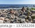Peaceful rocky shoreline with balanced stones atop a rock 137282208