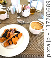 Cup of cappuccino and croissants with chocolate cream on plate 137283689