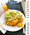 Served plate with omelet, salad, sausages. 137283691