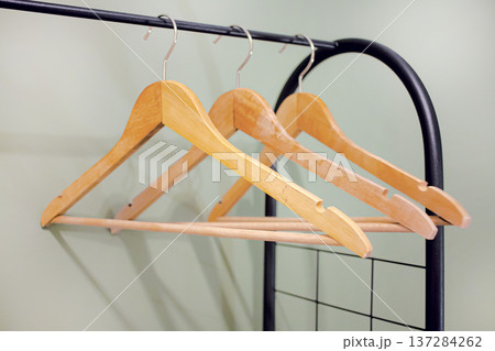 Wooden clothers hangers on rack Wooden clothers hangers on rack 137284262