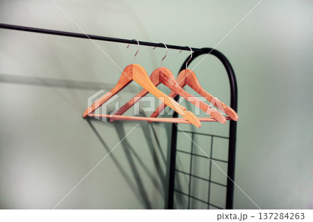 Wooden clothers hangers on rack Wooden clothers hangers on rack 137284263