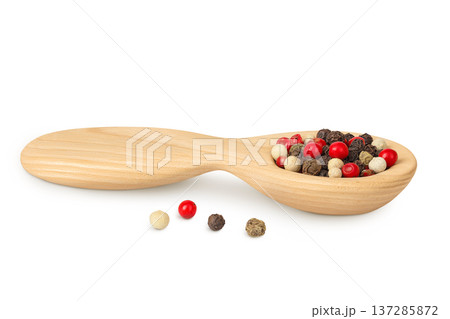 Pepper mix in a wooden spoon isolated on white background. Pepper mix in a wooden spoon isolated on white background. 137285872