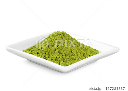 Green matcha powder in ceramic bowl isolated on white background. Top view 137285887