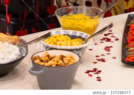 Buffet table with croutons, corn and hummus Buffet table with croutons, corn and hummus 137286257