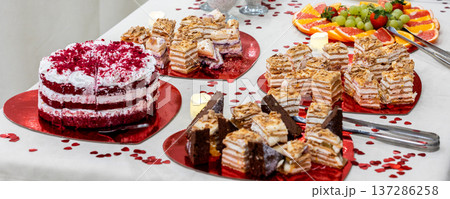 Dessert buffet with layered cakes and fresh fruit Dessert buffet with layered cakes and fresh fruit 137286258