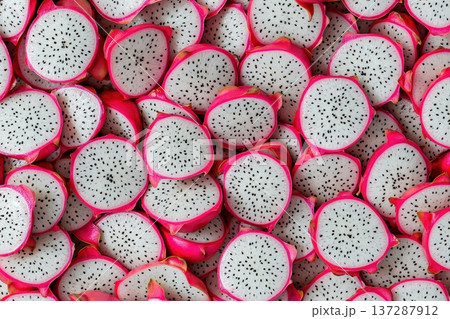 Close-Up of Fresh Dragon Fruit Slices Layered on a Vibrant Background Close-Up of Fresh Dragon Fruit Slices Layered on a Vibrant Background 137287912